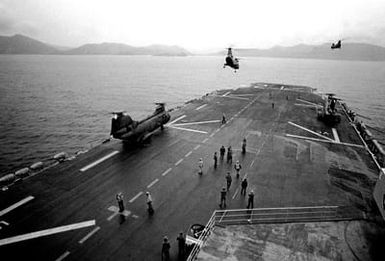 Two CH-46 Sea Knight helicopters lift off the deck of the amphibious assault ship USS SAIPAN (LHA-2) as two others prepare for take-off during the NATO exercise Display Determination '81 that took place September 19 to October 14, 1981