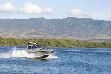 A U.S. Navy Military Police boat from Naval Station Pearl Harbor, Hawaii, patrols the base on Aug. 18, 2006. The boats provide security at waterways and harbor around-the-clock to protect U.S. Navy and foreign ships ported here at NS Pearl Harbor. (U.S. Navy photo by Mass Communications SPECIALIST 1ST Class Dennis C. Cantrell) (Released)