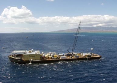 A port side view of the 450-10 Barge owned by Crowley Marine, anchored of the coast of Honolulu, Hawaii (HI), during recovery of the Japanese Fishing Vessel Ehime Maru