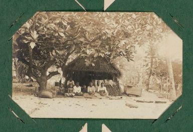 Group seated in a shelter under a breadfruit tree. From the album: Banaba (Ocean Island)