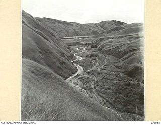 ZENAG, NEW GUINEA, 1944-02-27. LOOKING DOWN THE VALLEY TOWARDS THE BAR OF THE SNAKE RIVER FROM THE TOP OF THE "ZENAG JUMP UP" WHICH RISES 1,000 FEET IN UNDER A MILE