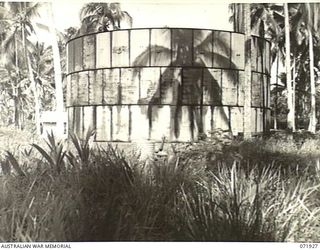 MILNE BAY, PAPUA, NEW GUINEA. 1944-04-01. A 350,000 GALLON TANK USED IN STORING INDUSTRIAL DIESEL OIL, ON THE WATERFRONT AT THE 2ND BULK PETROLEUM STORAGE COMPANY. THIS TANK, UNLIKE OTHER TANKS AT ..