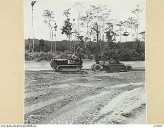 WAU - LAE ROAD, NEW GUINEA, 1944-03-10. A CARRY-ALL SCOOP DRAGGING GRAVEL FROM THE MARKHAM RIVER BANK ABOUT 87 MILES FROM WAU