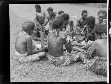 Male performers with bamboo tubes and a drum at the meke, Lautoka, Fiji