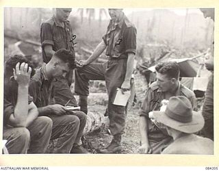 SUAIN PLANTATION, NEW GUINEA. 1944-12-08. A COMPANY, 2/4 INFANTRY BATTALION TROOPS ENGAGED IN PATROLLING AN AREA WEST OF THE DANMAP RIVER, RECEIVE CANTEEN SUPPLIES. IDENTIFIED PERSONNEL ARE:- ..