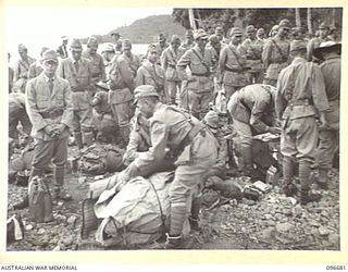 KAIRIRU ISLAND, NEW GUINEA. 1945-09-17. JAPANESE NAVAL OFFICERS PACKING THEIR BELONGINGS PRIOR TO BOARDING BARGES FOR TRANSFER TO MUSCHU ISLAND. FOLLOWING THE SURRENDER OF THE JAPANESE THE ISLANDS ..