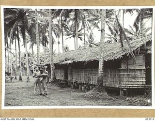 MILNE BAY, NEW GUINEA. 1943-06-26. VX11412 MAJOR V.M. BARKER (LEFT) AND QX40786 CAPTAIN J.S. MELLICK IN FRONT OF "G" OFFICE, HEADQUARTERS, 5TH AUSTRALIAN DIVISION AT GILI GILI