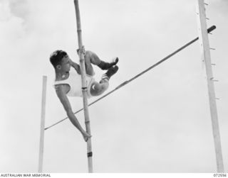 PORT MORESBY, NEW GUINEA. 1944-04-23. NX7287 PRIVATE G.R. MCLENNAN COMPETING IN THE POLE VAULT EVENT IN THE SPORTS MEETING CONDUCTED BY THE 2/101ST GENERAL TRANSPORT COMPANY AT 9 MILE