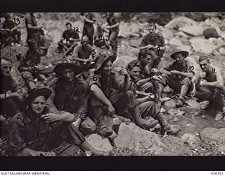 SALAMAUA AREA, NEW GUINEA. 1943-07-23. TROOPS OF "A" COMPANY, 2/5TH BATTALION RESTING AT BUIGAP CREEK AFTER THE HEAVY FIGHTING AT MOUNT TAMBU. THEY ARE: QX19681 LIEUTENANT K. J. P. MCCOY (1); ..