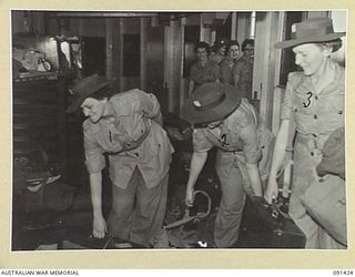 LAE, NEW GUINEA, 1945-05-07. AWAS PERSONNEL CHECKING THEIR GEAR IN THE DISEMBARKATION AREA. THEY WILL DISEMBARK FROM THE MV DUNTROON BY LANDING BARGE AT MILFORD HAVEN. THEY ARE PART OF A GROUP OF ..