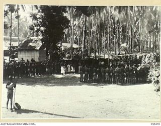 MILNE BAY, NEW GUINEA, 1943-05. VX12014 MAJOR-GENERAL E.J. MILFORD, DSO, GENERAL OFFICER COMMANDING 5TH AUSTRALIAN DIVISION, PRESENTING MEDALS TO NATIVES AT AHIOMA FOR LOYAL SERVICE GIVEN DURING ..