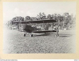 KIARIVU EMERGENCY LANDING GROUND, NEW GUINEA, 1945-08-13. THE GIPSY MOTH AIRCRAFT WITH FLYING OFFICER W.H.R. SMITH, 12 LOCAL AIR SUPPLY UNIT ROYAL AUSTRALIAN AIR FORCE AT THE CONTROLS TAKING OFF. ..