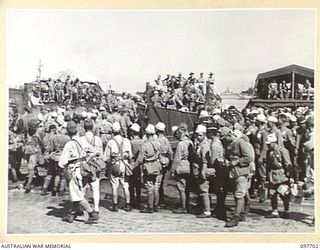 TOROKINA, BOUGAINVILLE. 1945-09-21. JAPANESE TROOPS FROM NAURU ISLAND, HAVING ARRIVED AT TOROKINA PER SS RIVER BURDEKIN, WAIT FOR THE TEN MILE MARCH TO THE PRISON COMPOUND TO BEGIN. THE MAJORITY OF ..