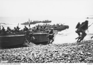 Saidor, New Guinea. 2 January 1944. United States troops rushing the beach as the landing craft came through the surf