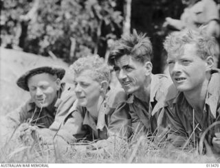 1942-10-19. FOUR MEN OF AN A.I.F. UNIT WHO HAVE SEEN SERVICE IN THE MIDDLE EAST, NOW IN ACTION SOMEWHERE IN THE NEW GUINEA FRONT. (NEGATIVE BY PARER)