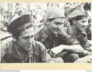 1943-09-15. NEW GUINEA. GOODVIEW JUNCTION. THREE TYPES OF HEADGEAR WORN BY THE A.I.F. AT GOODVIEW JUNCTION. PTE. KEITH BROWN OF NEW MARKET, VIC., WITH A U.S. GIGGLE HAT. PTE. HUGH MCGILL, OF ..