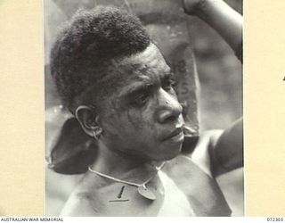 YAULA, NEW GUINEA. 1944-04-11. SOMA, AN AITAPE BOY CARRYING SUPPLIES DURING THE ADVANCE OF THE 57/60TH INFANTRY BATTALION TO BOGADJIM