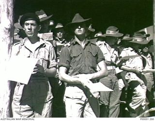 THE SOLOMON ISLANDS, 1945-08. A GROUP OF AUSTRALIAN SOLDIERS SINGING A HYMN DURING A THANKSGIVING SERVICE ON BOUGAINVILLE ISLAND. (RNZAF OFFICIAL PHOTOGRAPH.)