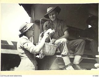 PORT MORESBY, NEW GUINEA. 1944-05-05. NX167046 CORPORAL M. GILCHRIST, 2/1ST MACHINE GUN BATTALION (2), WHO IS IN AN AMBULANCE AMONG DISCHARGED PATIENTS AT THE 2/1ST GENERAL HOSPITAL, RECEIVES ..