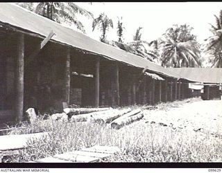 LAE, NEW GUINEA, 1946-01-11. SOME OF THE MANY STORAGE HUTS AT AUSTRALIAN ARMY CANTEENS SERVICE BULK STORES