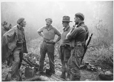 Major G. R. Warfe, Lieutenants E. J. Barry, J. E. Lewin and S. Read (from left to right), at the summit of Timber Knoll, Orodubi, New Guinea, July 1943
