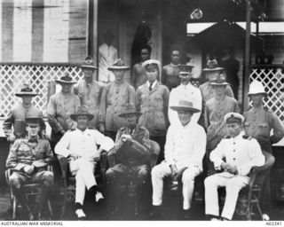 Group portrait of Australian Navy and Military Expeditionary Force (AN&MEF) Officers at German New Guinea. Back row (in background), left to right: Gunner Young RAN; unidentified native; ..