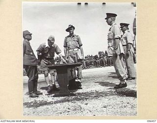 CAPE WOM, NEW GUINEA, 1945-09-13. JAPANESE INTERPRETER READING THE SURRENDER TERMS TO LIEUTENANT-GENERAL H. ADACHI, COMMANDER 18 JAPANESE ARMY IN NEW GUINEA. LIEUTENANT-GENERAL ADACHI FORMALLY ..