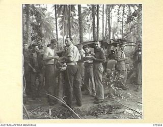 LAUNCH JETTY, NEW GUINEA: 1944-01. PATIENTS ENJOY AN EARLY MORNING BREAKFAST DURING A MESS PARADE AT THE ADVANCED DRESSING STATION, LAUNCH JETTY, 10TH FIELD AMBULANCE