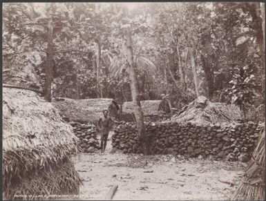 A man standing in the village at Matema, Reef Islands, 1906 / J.W. Beattie