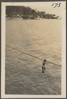 Man on a flying fox, Samarai, Papua New Guinea, probably 1916