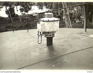 MILNE BAY, NEW GUINEA. 1944-04-04. A PRESSURE AND VACUUM VALVE POSITIONED ON THE TOP OF A 500,000 GALLON TANK AT THE 2ND AUSTRALIAN BULK PETROLEUM STORAGE COMPANY TO PERMIT THE INTAKE AND OUTPUT OF ..