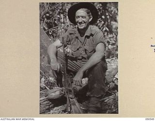 WONGINARA MISSION, NEW GUINEA. 1945-04-06. WARRANT OFFICER I W.R. EDMONSTON, 2/3 INFANTRY BATTALION (1), WHO WATCHED A JAPANESE SNIPER CLIMB INTO A TREE AND THEN SHOT HIM OUT OF IT