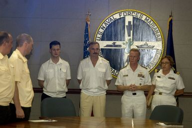 CHIEF of STAFF (CS) and First Deputy Commander of Russian Federated Navy (RFN) Pacific Fleet, Vice Admiral (VADM) Konstantin Sidenko (center) and US Navy (USN) Commander of US Naval Forces Marianas (USNFM) Rear Admiral (RADM) (Upper Half) Joe Leidig (second from right) speak to officers of the USN and Russian Navy at the exercise brief for passing Exercise (PASSEX) 06 at Naval Base (NB) Guam (GU). PASSEX 06 is an exercise designed to increase interoperability between the two navies while enhancing the strong cooperative relationship between Russia and the United States