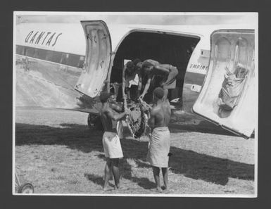 [A native patient being lifted on board a Qantas plane at an outstation strip to be flown to a base hospital for specialist treatment, Papua and New Guinea] Australian News and Information Bureau