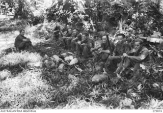 BOUGAINVILLE ISLAND. 1945-02-12. TROOPS OF NO 11 PLATOON, "B" COMPANY, 9TH INFANTRY BATTALION ENJOYING A SMOKE AFTER CHECKING OVER JAPANESE PILLBOXES ON BOTH SIDES OF THE MAWARAKA- MOSIGETTA ROAD. ..