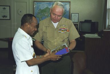 (LGEN) D'Wayne Gray, commanding general, Fleet Marine Force Pacific, presents a gift to Admiral Romly, chief of staff, Indonesian Navy