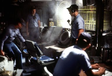 Smoke filters through the area after a fire was extinguished near a radar tracking screen during a drill aboard the amphibious assault ship USS GUAM (LPH 9)