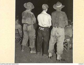 PORT MORESBY, PAPUA, 1944-02-25. AUSTRALIAN AND AMERICAN SERVICEMEN WATCHING A FILM AT AN AMERICAN HOSPITAL