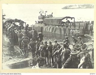 SARANG, NEW GUINEA. 1944-05-31. TROOPS AND STORES OF THE 37/52ND INFANTRY BATTALION BEING LANDED FROM AMERICAN LANDING BARGES. THE AREA IS USED AS A FORWARD BASE DURING THE PREPARATIONS FOR THE ..