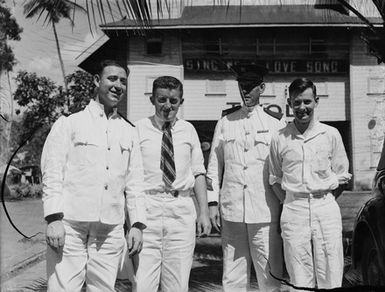 [Group portrait of four men in uniform]