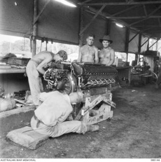 NADZAB, NEW GUINEA. 1044-06-26. GROUND CREW AT NO. 4 TACTICAL RECONNAISSANCE SQUADRON, ROYAL AUSTRALIA AIR FORCE, OVERHAULING A P.38 ALLISON ENGINE