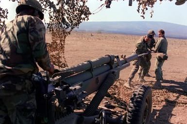 Members of the 4th Section of Btry. C, 2nd Bn., 11th Field Arty., 25th Inf. Div., clean their M-102 105mm howitzer during live-fire artillery exercises at the U.S. Army's Pohakuloa Training Area. Their unit is preparing for Team Spirit '84, a joint South Korean/U.S. training exercise held annually in Korea