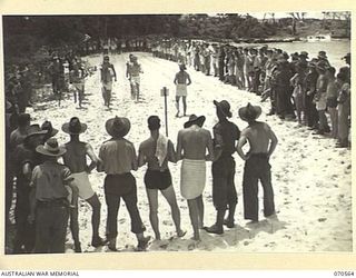 KELANOA, NEW GUINEA, 1944-02-20. THE COMBINED TEAM FROM THE ROYAL AUSTRALIAN ENGINEERS AND THE ROYAL AUSTRALIAN ARTILLERY IN THE MARCHPAST AT A 5TH AUSTRALIAN DIVISION BEACH CARNIVAL. THE CARNIVAL ..