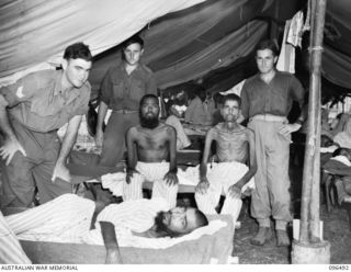 RABAUL, NEW BRITAIN, 1945-09-12. EMACIATED INDIAN SERVICEMEN IN HOSPITAL AT 4 FIELD AMBULANCE FOLLOWING THEIR RELEASE FROM JAPANESE CUSTODY AFTER AN AUSTRALIAN FORCE FROM 4 INFANTRY BRIGADE ..