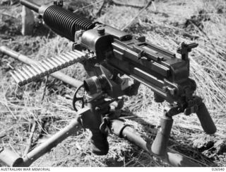 PAPUA, NEW GUINEA. 1942-09-07. CLOSE UP OF JAPANESE 7.7 MILLIMETRE MACHINE GUN CAPTURED AT MILNE BAY. AIR COOLED AND GAS-OPERATED IT WEIGHS ABOUT 130 POUNDS AND CAN BE CARRIED BY TWO OR THREE MEN ..