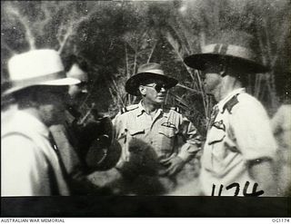 AITAPE, NORTH EAST NEW GUINEA. C. 1944-06. LEFT TO RIGHT: ARTHUR DRAKEFORD, THE MINISTER FOR AIR, JOHN DEDMAN, THE MINISTER FOR WAR ORGANISATION OF INDUSTRY, AIR COMMODORE F. R. W. SCHERGER, THE ..