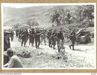 WALINGAI, NEW GUINEA. 1943-12-29. MEMBERS OF THE 2/24TH AUSTRALIAN INFANTRY BATTALION MOVING UP TO THE FORWARD AREAS FROM WALINGAI. IDENTIFIED PERSONNEL ARE: VX75430 PRIVATE F. L. KEECH; VX76159 ..