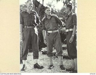 SIAR, NEW GUINEA. 1944-06-23. OFFICERS OF THE 57/60TH INFANTRY BATTALION IN THE OFFICER'S TENT LINES. IDENTIFIED PERSONNEL ARE:- VX81073 CAPTAIN R.M. MARTIN (1); VX108132 LIEUTENANT-COLONEL R.R. ..