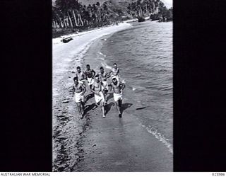 PORT MORESBY, PAPUA, 1942-07-20. HAVING ENJOYED A SWIM AFTER A DAY'S WORK, THESE AUSTRALIAN TROOPS LOOSEN UP WITH A BRISK RUN ALONG THE BEACH