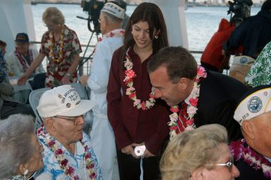 US Senator Jim Reynolds (Republican-Oklahoma) and his daughter speak with retired CHIEF Engineman (ENC) Charles W. "Slip" Hailslip about his experiences on board USS Arizona, the day Pearl Harbor was attacked. More than 200 distinguished visitors and Pearl Harbor survivors attended the Remembrance Ceremony